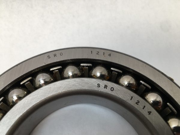 SRO 1214 double row self-aligning ball bearing, 70mm ID x 125mm OD x 24mm Width, with stamped steel cage. Accommodates angular misalignment, 5300 rpm limit, ideal for simple mounting in industrial machines globally.