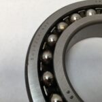 SRO 1214 double row self-aligning ball bearing, 70mm ID x 125mm OD x 24mm Width, with stamped steel cage. Accommodates angular misalignment, 5300 rpm limit, ideal for simple mounting in industrial machines globally.