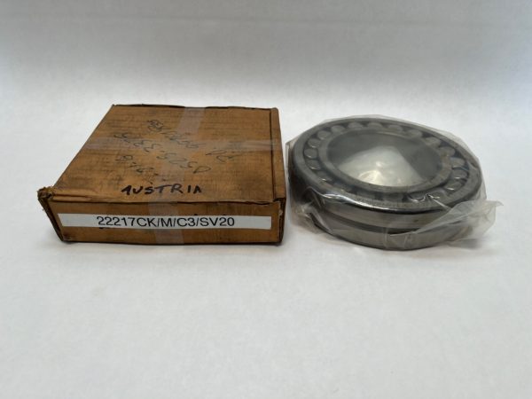 Steyr 22217CK/M/C3 spherical roller bearing shown in plastic wrap next to its labeled box
