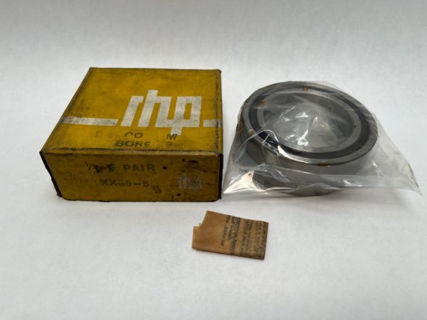RHP XX65-5Q angular contact ball bearing in a plastic bag beside its yellow RHP branded box