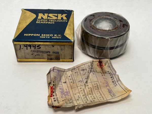 NSK 7306BTDBC8P5 angular contact ball bearing wrapped in plastic beside its box and inspection card