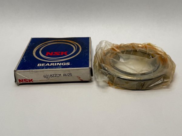 NSK 6018ZZCM metal shielded bearing in plastic wrap next to its NSK bearings box