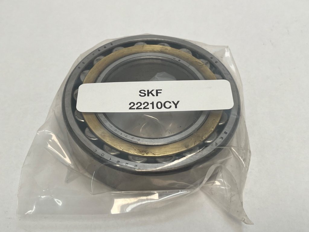 SKF 22210-CY spherical roller bearing, 50mm ID x 90mm OD x 23mm Width, featuring a standard stamped steel cage and straight bore. Handles heavy radial loads and misalignment, suited for equipment in the US.