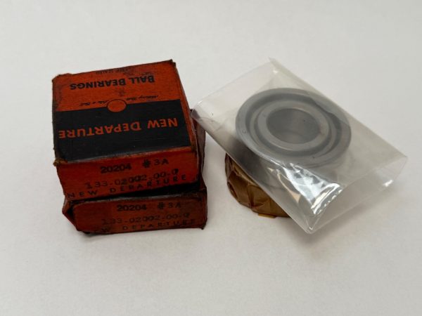 NDH 20204DTL3A angular contact ball bearing in plastic wrap next to two stacked New Departure boxes