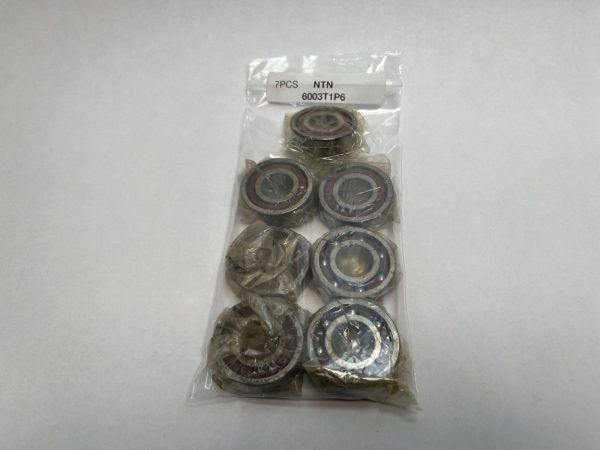 Pack of 7 NTN 6003T1P6 deep groove ball bearings in a sealed plastic bag with label