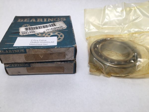 Two stacked Fafnir 2MM210WIDUM bearing boxes beside a bagged angular contact ball bearing