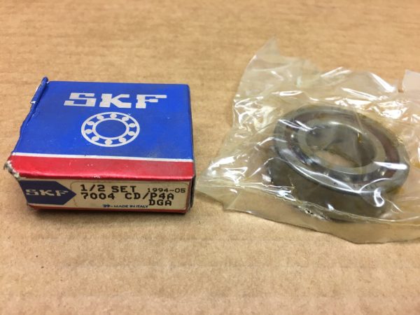 SKF 7004 CD/P4A DGA angular contact ball bearing in plastic wrap beside its original box