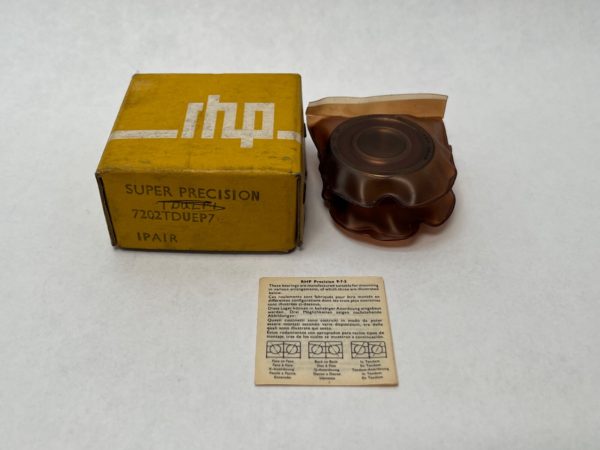 RHP 7202TDULP4 angular contact ball bearing pair wrapped in plastic beside its yellow Super Precision box