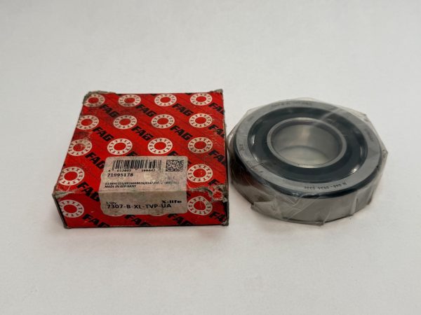 FAG 7307-B-XL-TVP-UA angular contact ball bearing next to its red FAG packaging box