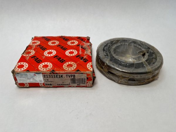 FAG spherical roller bearing next to its original red FAG packaging box