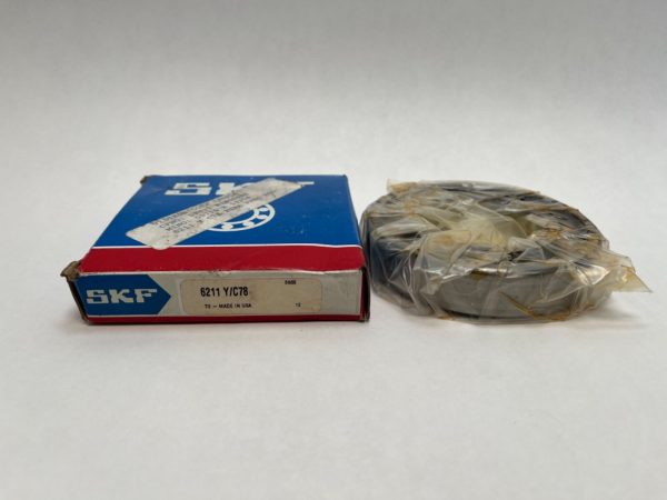 SKF 6211 Y/C78 deep groove ball bearing shown next to its original labeled SKF box