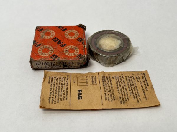 FAG B71904CTPAP4UL angular contact ball bearing shown wrapped in plastic beside its orange box and instruction sheet