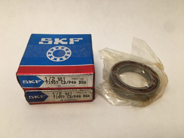 Two SKF 71907-CD/P4A DGA boxes beside one angular contact ball bearing in plastic wrap