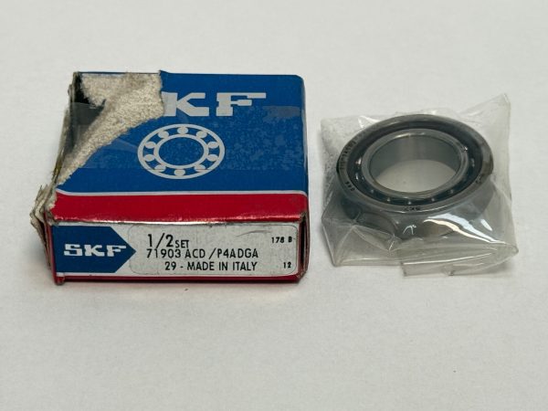 SKF 71903ACD/P4ADGA angular contact bearing in plastic wrap beside its labeled SKF box