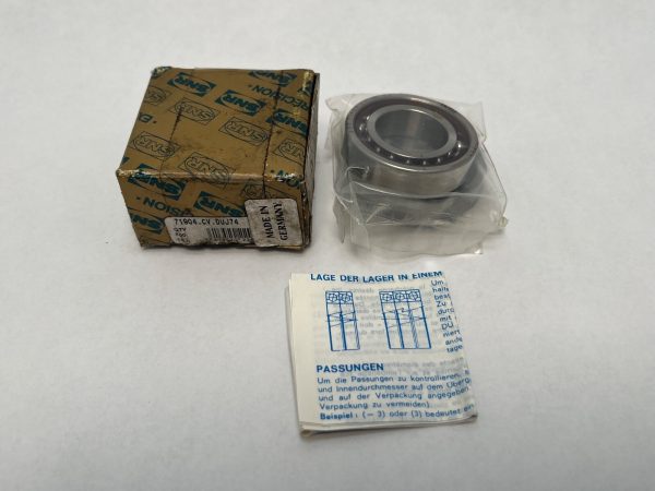 SNR 71904CVDUJ74 angular contact ball bearing shown unwrapped beside its original box and instruction sheet