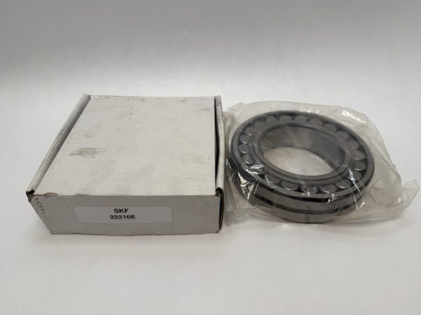 SKF 22216E spherical roller bearing in plastic wrap next to its labeled box
