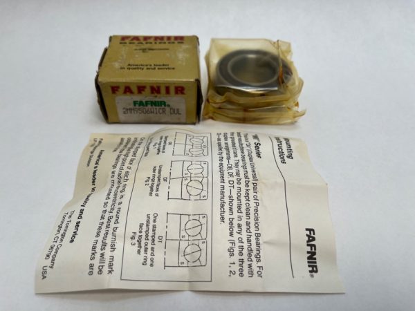Fafnir bearing box, bearing in plastic wrap, and mounting instruction sheet on white background