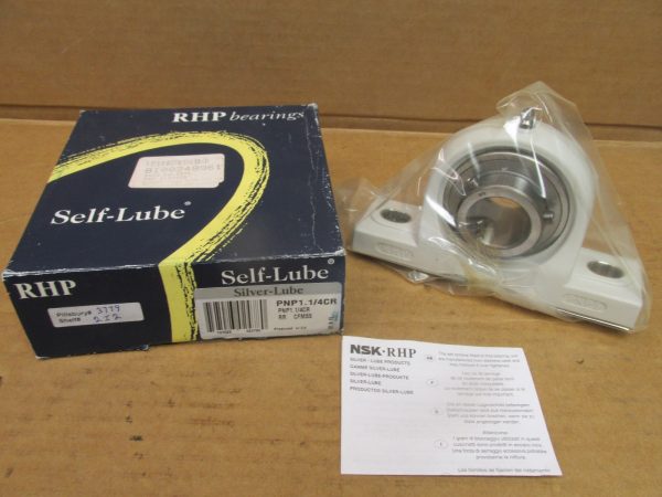 NSK PNP1.1/4CR pillow block bearing, cast iron housing, shown wrapped in plastic next to its RHP Self-Lube box