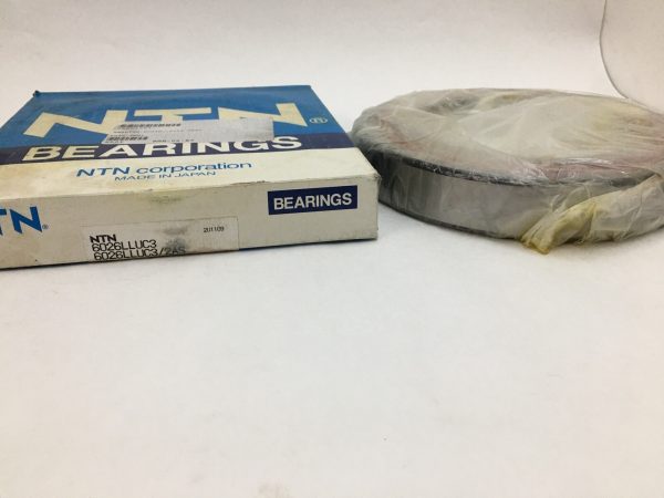 NTN 6026LLUC3 deep groove ball bearing in plastic wrap beside its NTN branded box