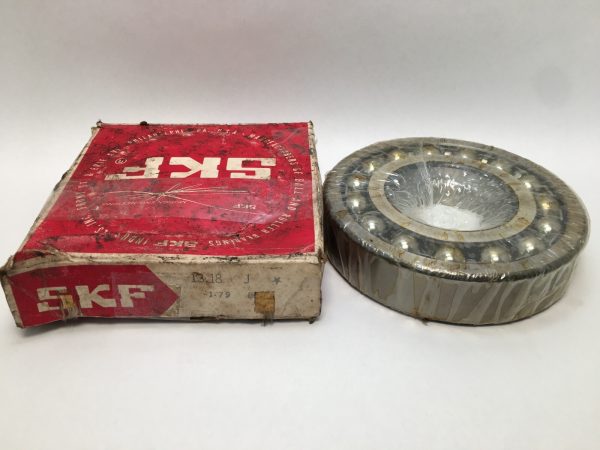 SKF 1318J self-aligning ball bearing, shrink-wrapped, beside its original red SKF box
