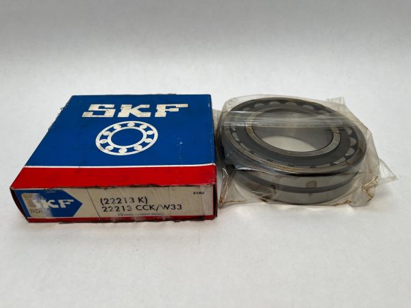 SKF 22213CCKW33 spherical roller bearing shown in plastic wrap next to its SKF box