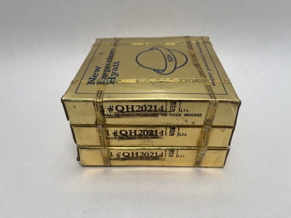 Three stacked gold New Departure Hyatt boxes labeled QH20214 angular contact ball bearings