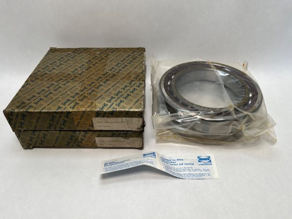 SNR 7022CVDUJ74 angular contact ball bearing in plastic wrap next to its branded box and fitting instructions