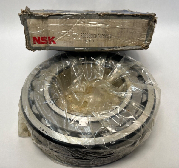 NSK 22228CDKE4C3S11 spherical roller bearing, shrink-wrapped, beside its original box