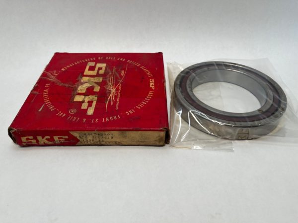 SKF 7020CTCC78 angular contact ball bearing in plastic wrap beside its red SKF box