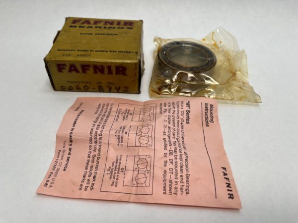 Fafnir bearing box, oil-wrapped bearing, and pink mounting instructions sheet on white background