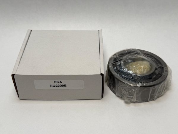 SKA NU2309E cylindrical roller bearing in plastic wrap next to its labeled packaging box