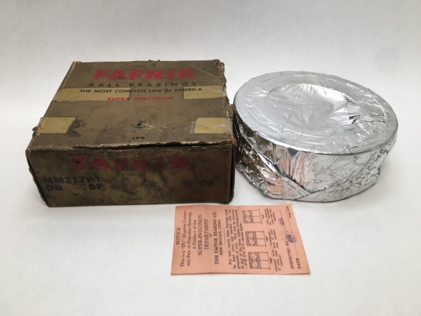 Fafnir MM217WIDB angular contact ball bearing wrapped in foil beside its original worn box and inspection slip