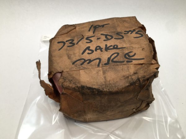 MRC 7315DS angular contact ball bearing wrapped in original paper packaging with handwritten label, in plastic bag