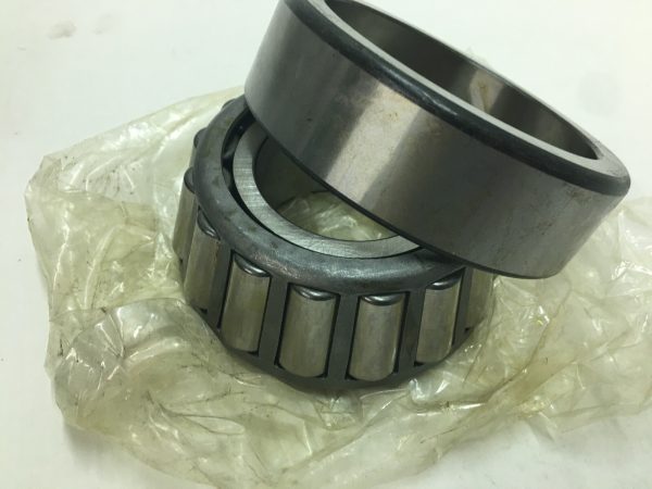 NTN 32312U tapered roller bearing cup and cone set resting on plastic packaging