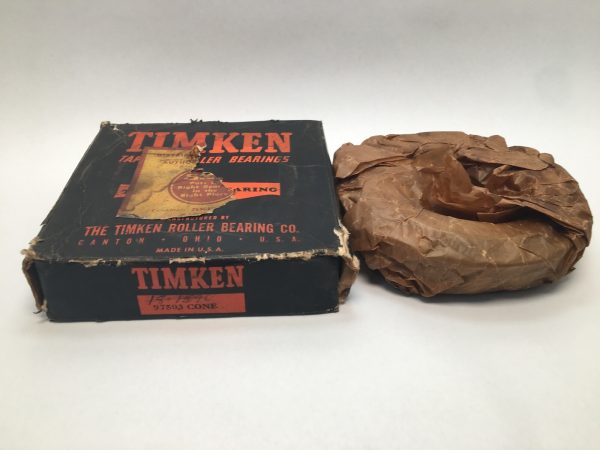 Timken 97503 tapered roller bearing cone wrapped in paper beside its original labeled box