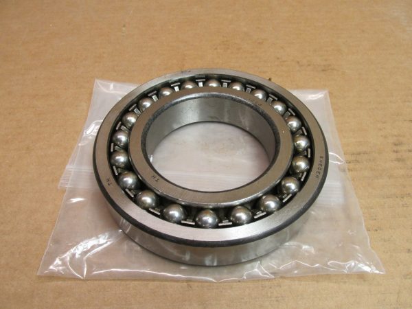 SKF 1220 self-aligning ball bearing, open design, sitting in a plastic bag on a box