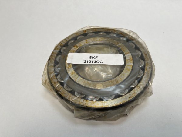 SKF 21313CC spherical roller bearing, wrapped in plastic, with label visible on the bore