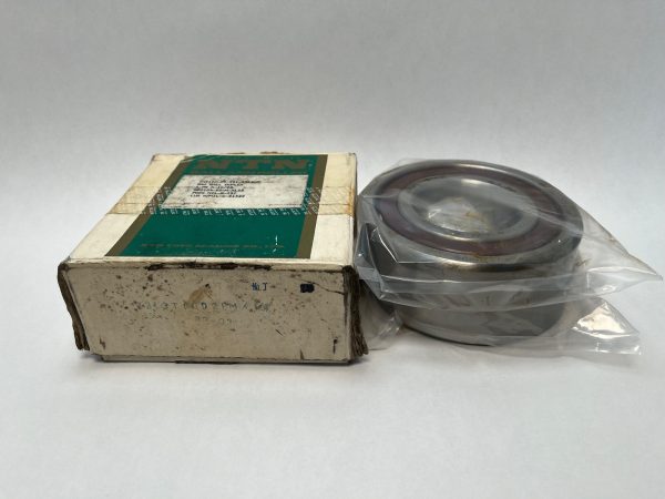 NTN 7313T1GD2GLPM angular contact ball bearing beside its original labeled box, in plastic packaging