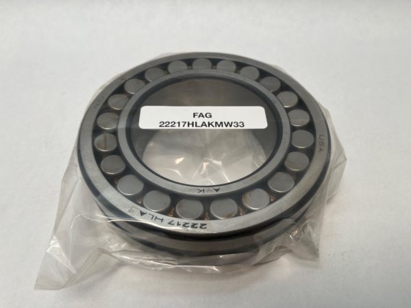 FAG 22217HLAKMW33 spherical roller bearing with tapered bore, shown in plastic packaging with label