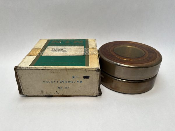 NTN 7313T1GD2GLPM angular contact ball bearing stacked beside its original labeled box
