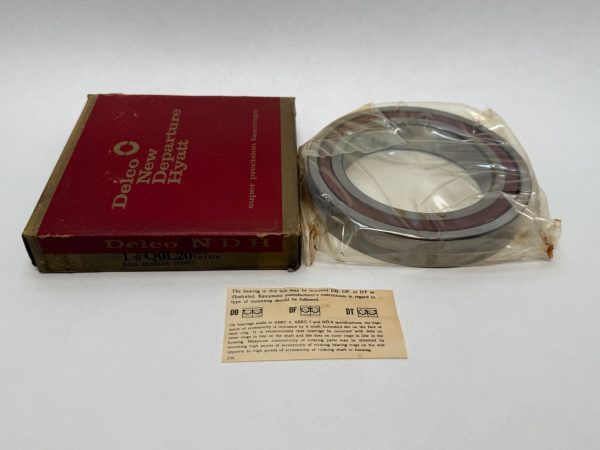 NDH Q0L20DTX7A angular contact bearing in plastic wrap next to its Delco New Departure Hyatt box and mounting instructions ca