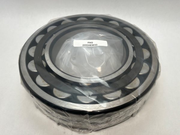 FAG 22234EW33 spherical roller bearing, wrapped in plastic, showing rollers and cage