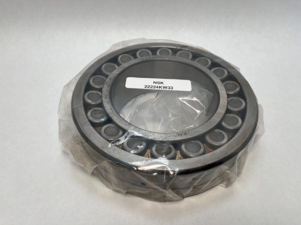 NSK 22224KW33 spherical roller bearing with tapered bore, shown wrapped in plastic with label