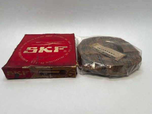 SKF 7219CTCC78 angular contact ball bearing next to its red SKF box, wrapped in paper