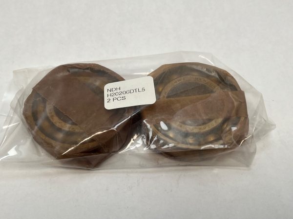 Two NDH H20206DTL5 angular contact ball bearings wrapped in paper, sealed in a plastic bag labeled 2 PCS