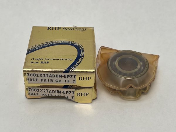 RHP 7002CTDUMP4 angular contact bearing matched duplex pair, unwrapped unit beside two stacked boxes