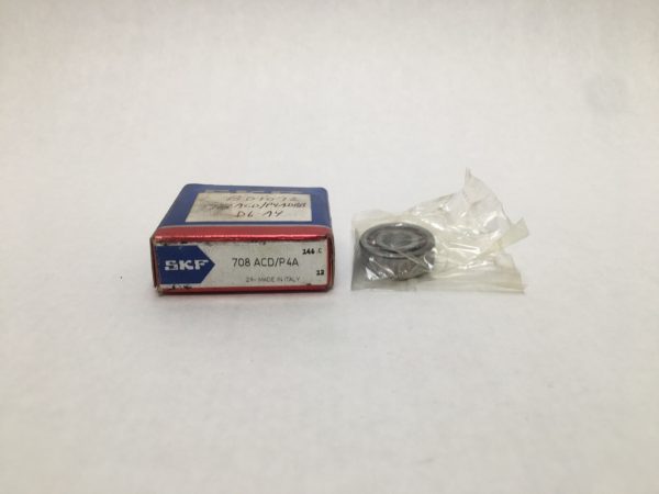SKF 708 ACD/P4A angular contact ball bearing beside its labeled SKF box, partially unwrapped in plastic