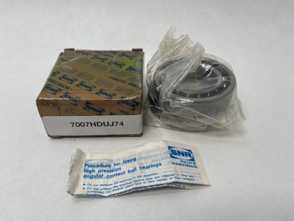 SNR 7007HDUJ74 angular contact ball bearing in plastic wrap next to its labeled box and instruction sheet
