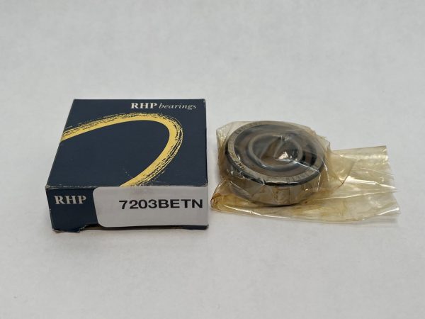 RHP 7203BETN angular contact ball bearing in plastic wrap next to its RHP branded box