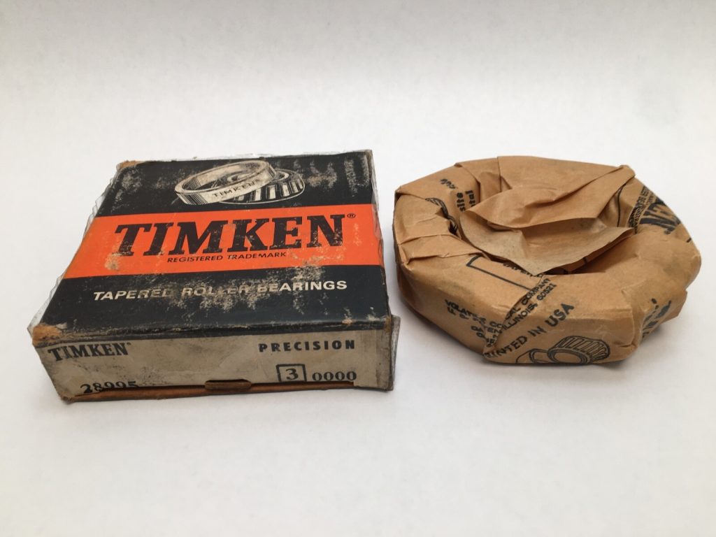 Timken 28995-3 tapered roller bearing cone next to its original box, wrapped in paper